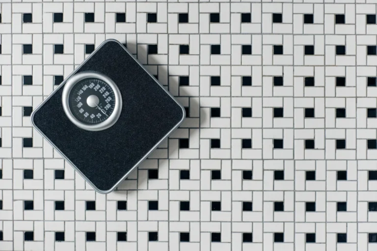 A bathroom scale found on a tiled floor