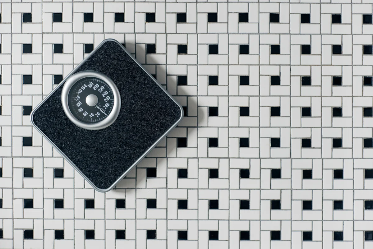 A bathroom scale found on a tiled floor