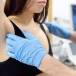 Doctor mammologist examines woman breasts and lymph nodes. Correcting the shape of the breast - lift, reduction, reconstruction, augmentation. Problems of lactation. Breast cancer.