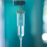 Set iv fluid intravenous drop saline drip hospital room,Medical Concept,treatment emergency and injection drug infusion care chemotherapy, concept.blue light background,selective focus stock photo